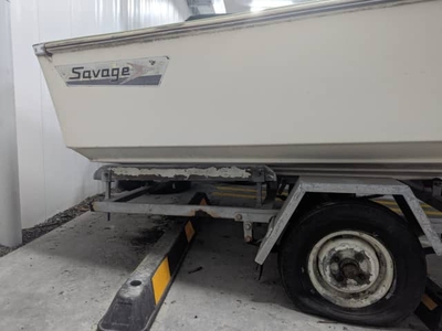 14 foot Savage fibreglass boat on a trailer